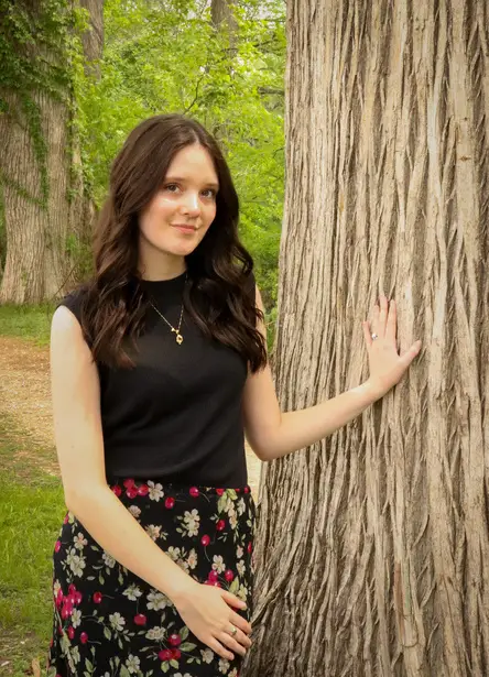 Kayley Cannon standing beside a tree